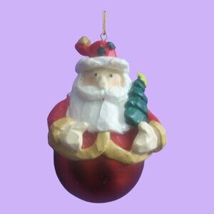 Round ball ornament bottom Santa with tree on hat and in hand in red and white